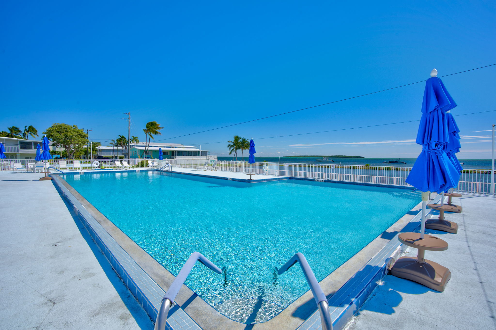 Oceanfront pool offering panoramic views of the sparkling sea, ideal for resort-style living in the Florida Keys.